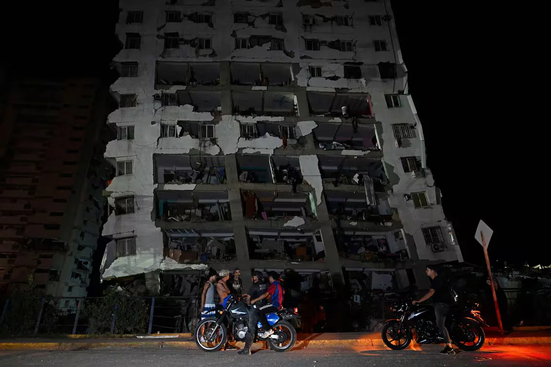 people-gather-outside-a-damaged-building-6VZZQXI35BAAFMEBKFMG2ANDV4